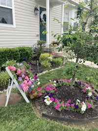 a flower bed in front of a house