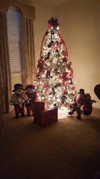 a christmas tree in a living room with decorations