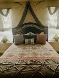 a bed in a bedroom with a canopy over it